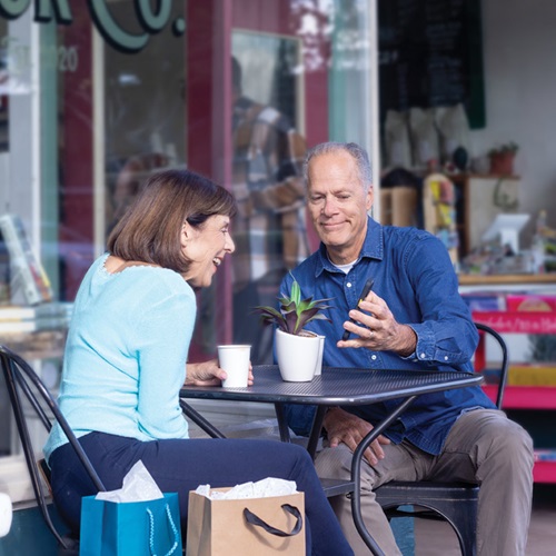 Elderly couple looking at the new guaranteed income calculator on their mobile device. 