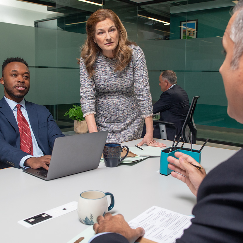 Three coworkers discussing check fraud