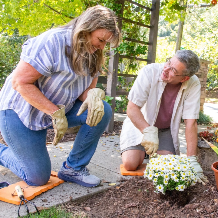 A couple gardening with piece of mind thanks to their annuity policy