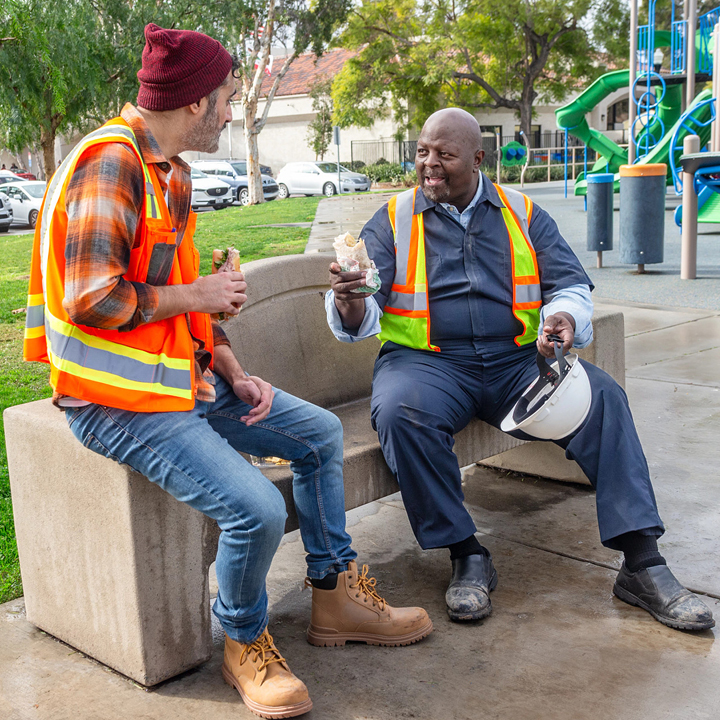 Two construction workers talking over their lunch break