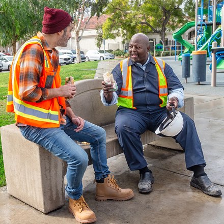 Two construction workers talking over their lunch break