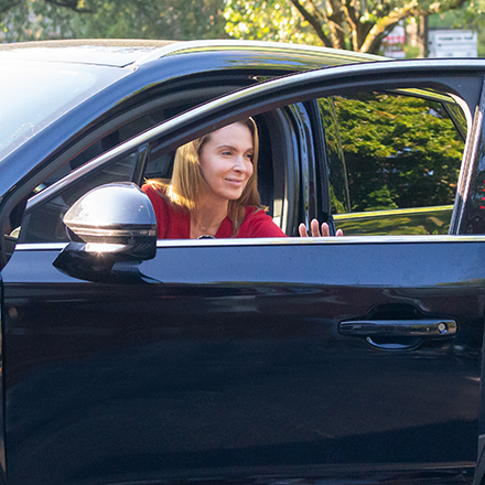 Woman stepping out of her car