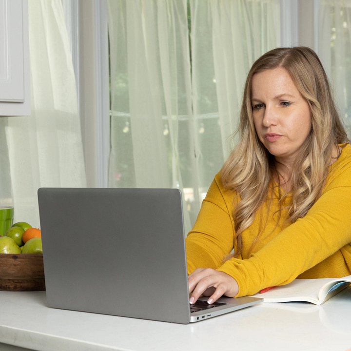 Woman purchasing auto insurance on her computer