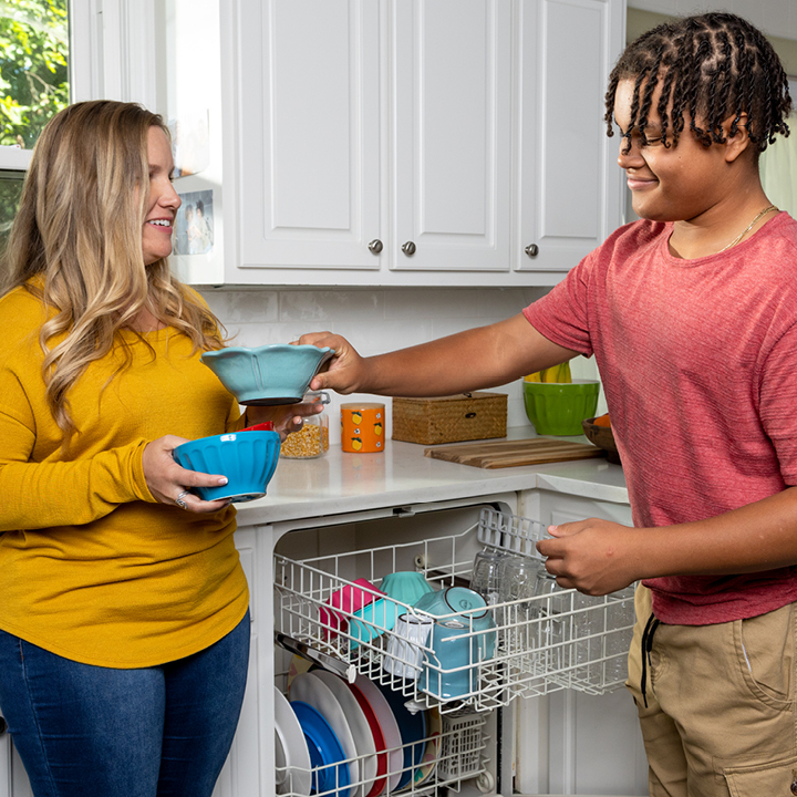 A mother and son putting dishes away