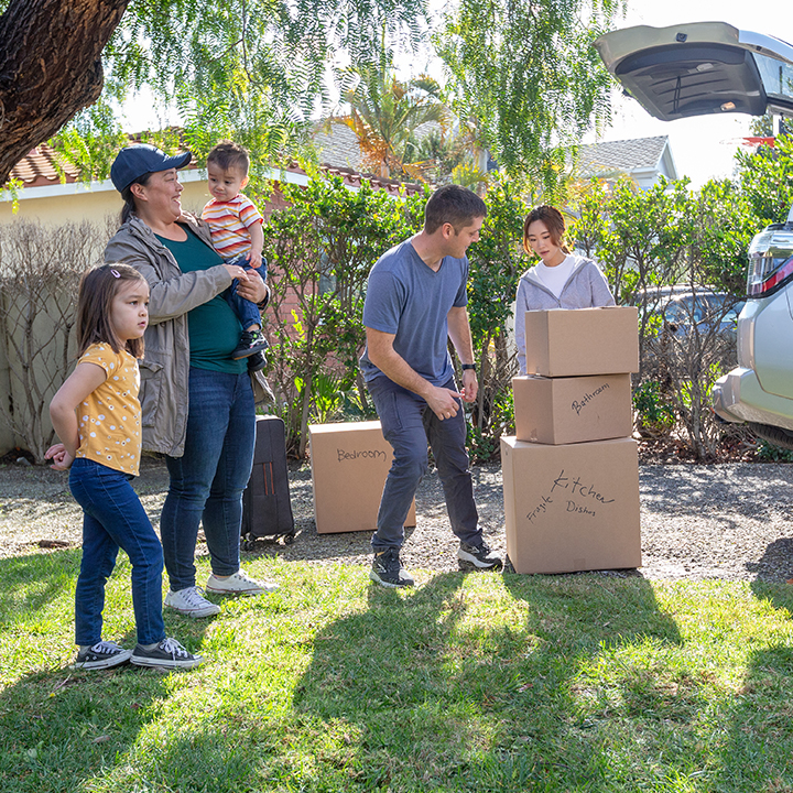 A family unloading boxes from their vehicle