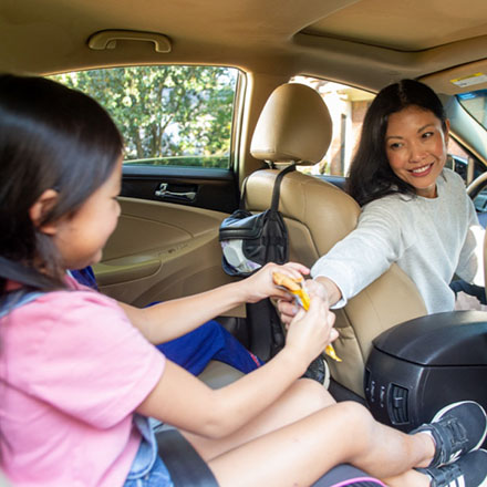 Mom and daughter in their car protected by a term life policy