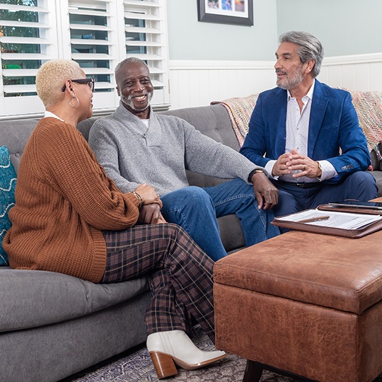 A family talks with an accredited financial advisor about TruStage investment options