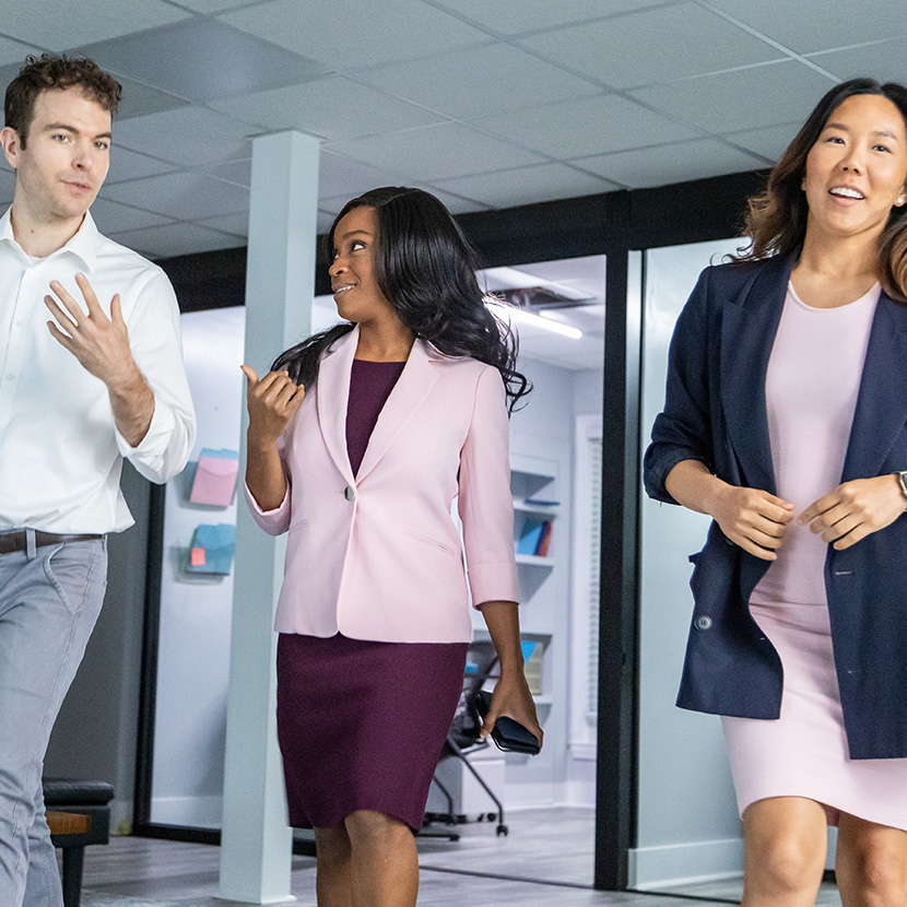 Coworkers discussing the news of TruStage being recognized as one of the top ten global organizations and teams in Diversity Equity and Inclusion (DEI).