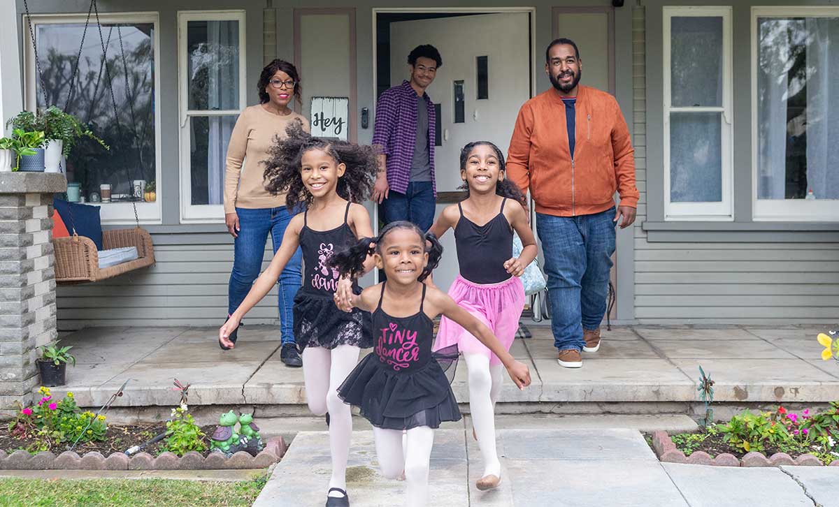 A family outside their home uses the Behavioral Finance Advice program to help make more intentional investment choices.