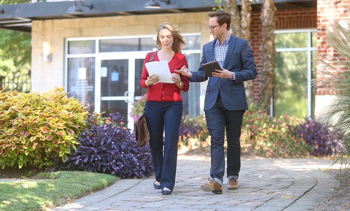 Two appointed financial professionals are discussing Elevate™ advanced planning resource while on a walk.