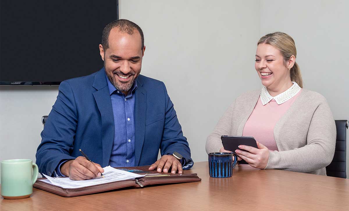 A financial professional, appointed with TruStage™, discusses annuities with a client in his office.