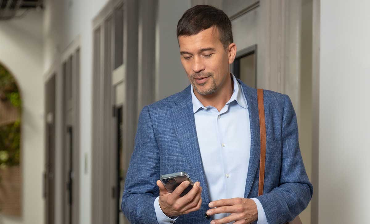 A financial professional reads TruStage™ annuities resources on his mobile device to help grow his business.