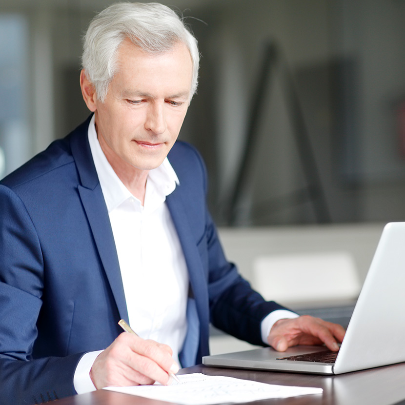 A financial professional reviews the TruStage™ annuities blog on his laptop to grow his skills and attract, retain, and grow clients.