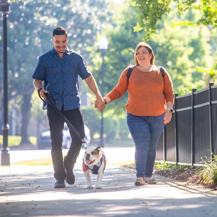 Couple walking dog discussing no medical exam life insurance