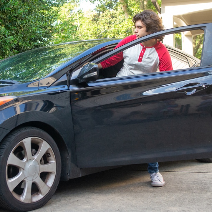 A man gets into a car with the knowledge of what to do after a car accident.