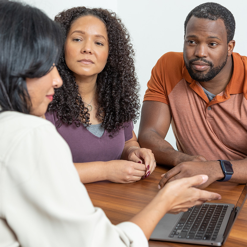 Three African-American business owners are discussing  their company's retirement program from TruStage™