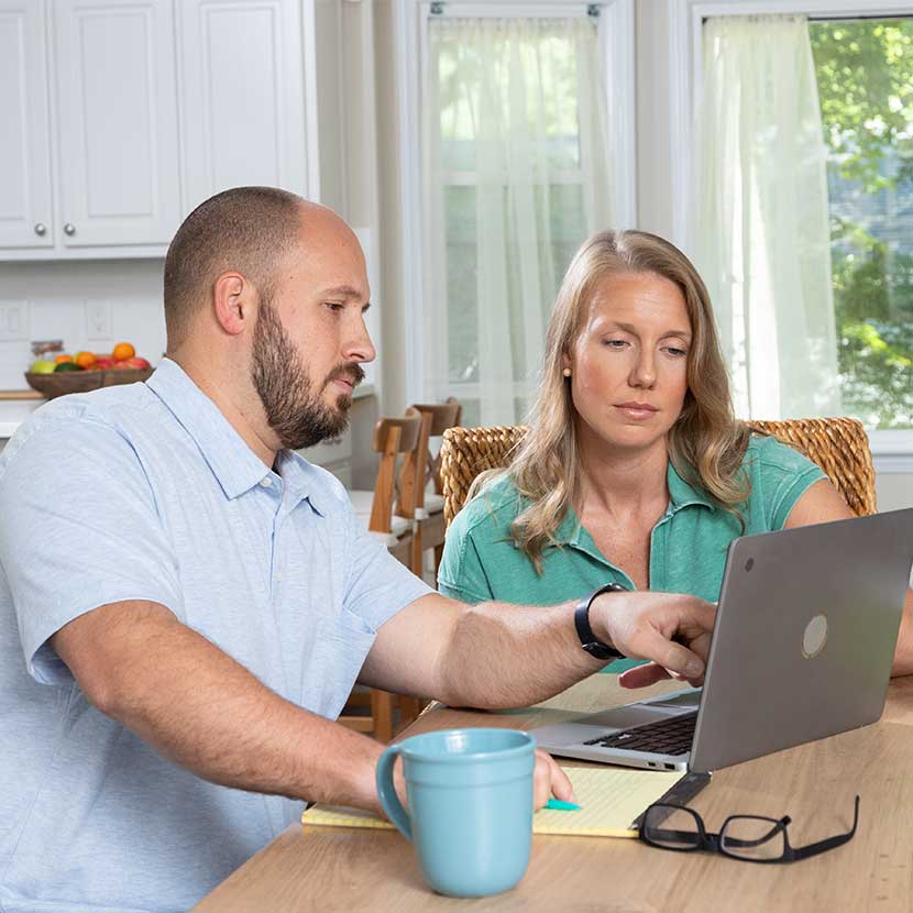 A couple discusses the performance of their TruStage-assisted retirement plan over morning coffee.